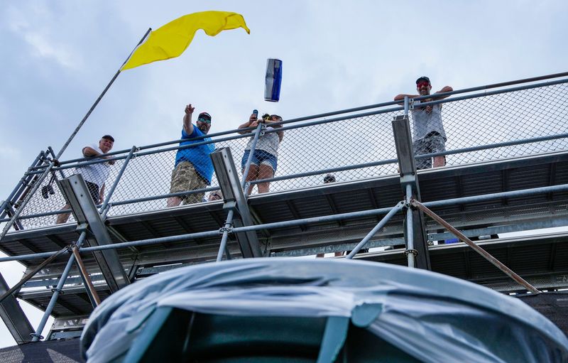 Adam Badanek from Speedway tosses a beer into a trash can Wednesday, May 14, 2025, ahead of practice for the 109th running of the Indianapolis 500 at Indianapolis Motor Speedway.