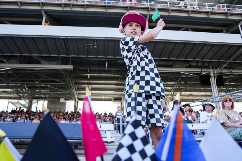 Baron Doyle, 8, of Brownsburg waves his green flag Sunday, May 18, 2025, during the top 12 qualifying ahead of the 109th running of the Indianapolis 500 at Indianapolis Motor Speedway.