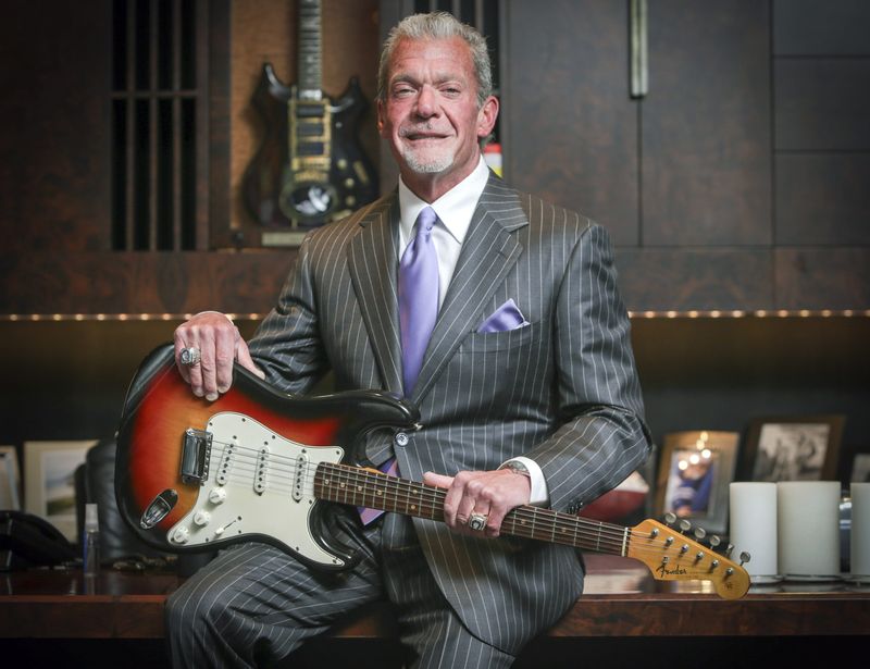 Jim Irsay holds the Fender Stratocaster guitar that Bob Dylan played at the Newport Folk Festival in 1965. Photo taken on June 10, 2014.