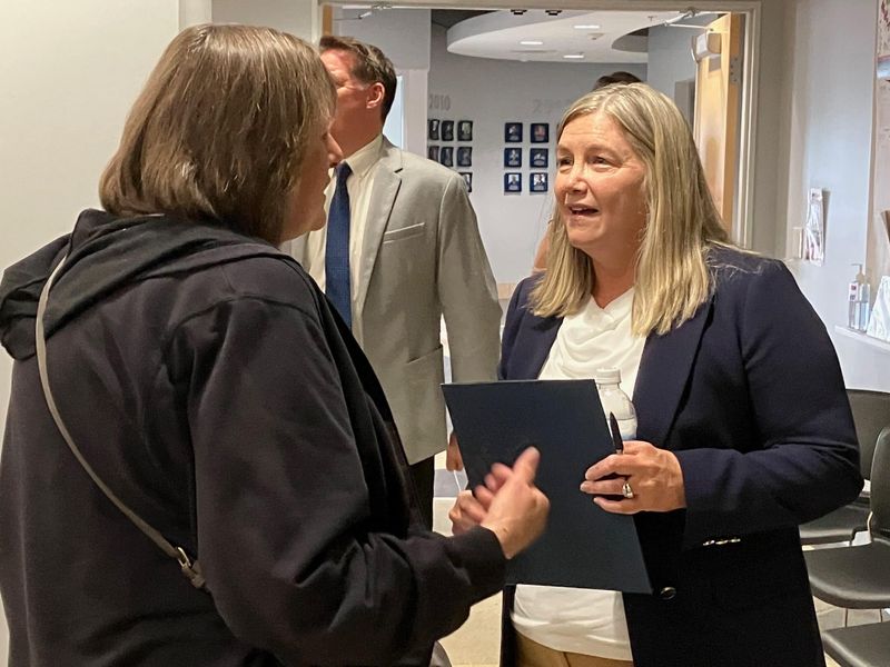 New Evansville Vanderburgh School Corp. Superintendent Darla Hoover speaks with an attendee at the May 19 school board meeting.