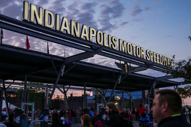 Racing fans walk through the entrance Sunday, May 25, 2025, ahead of the 109th running of the Indianapolis 500 at Indianapolis Motor Speedway.