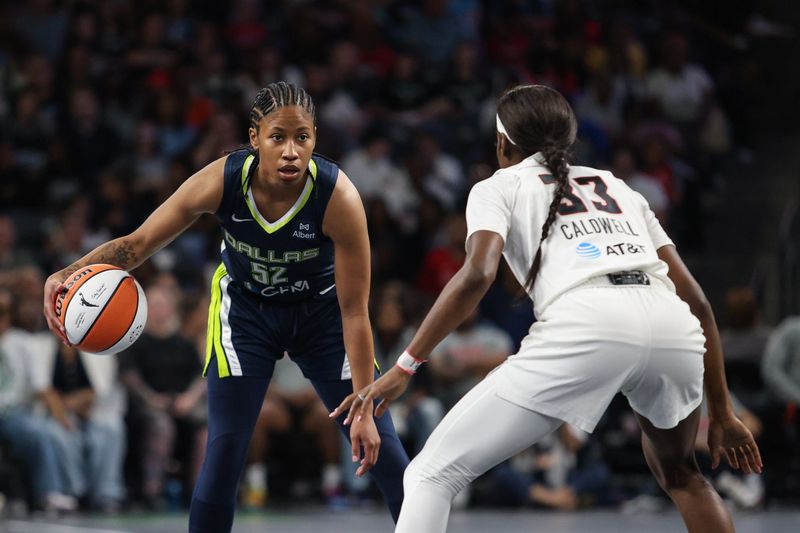 May 24, 2025; College Park, Georgia, USA; Atlanta Dream guard Maya Caldwell (33) plays defense against Dallas Wings guard Tyasha Harris (52) during the first quarter at Gateway Center Arena at College Park. Mandatory Credit: Jordan Godfree-Imagn Images