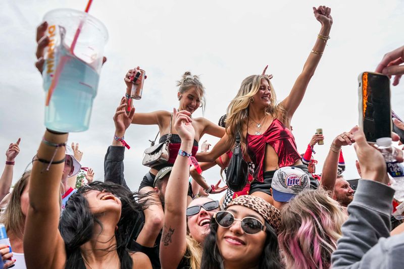 Concertgoers dance in the snake pit Sunday, May 25, 2025, during the 109th running of the Indianapolis 500 at Indianapolis Motor Speedway.