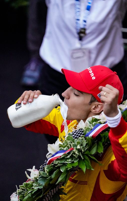 Chip Ganassi Racing driver Alex Palou (10) drinks milk in victory lane after winning the 109th running of the Indianapolis 500 Sunday, May 25, 2025, at Indianapolis Motor Speedway.