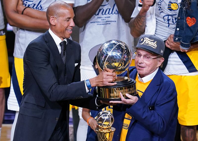Reggie Miller hands the Eastern Conference Championship trophy to Herb Simon on Saturday, May 31, 2025, after defeating the New York Knicks at Gainbridge Fieldhouse in Indianapolis.
