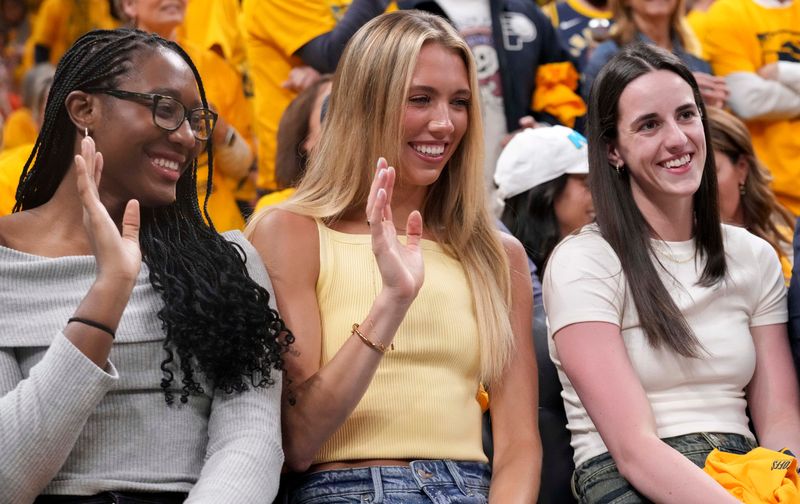 From left, Indiana Fever players (from left) Aliyah Boston, Lexie Hull and Caitlin Clark sit court side during Game 6 of the NBA Eastern Conference Finals between the Indiana Pacers and New York Knicks on Saturday, May 31, 2025, at Gainbridge Fieldhouse in Indianapolis. The Pacers defeated the Knicks 125-108.