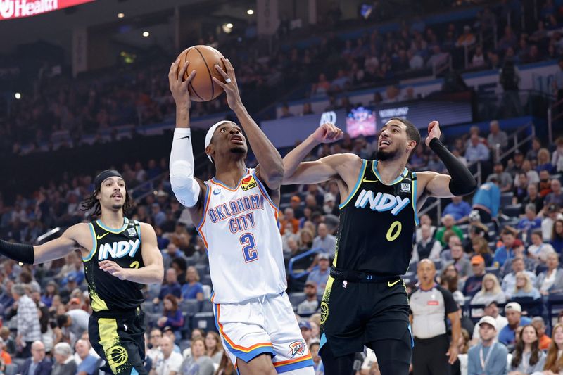 Oklahoma City Thunder guard Shai Gilgeous-Alexander (2) drives to the basket beside Indiana Pacers guard Tyrese Haliburton (0) during the first quarter at Paycom Center.