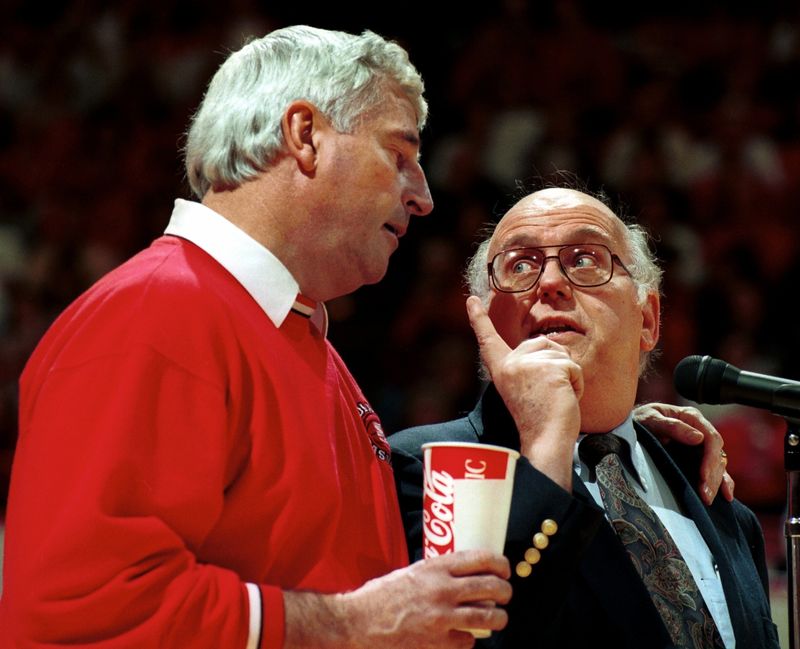 Former Indiana University basketball coach Bob Knight congratulates Bob Hammel on his retirement as sports editor of the Herald-Times during a senior day ceremony in Assembly Hall on March 10, 1996.