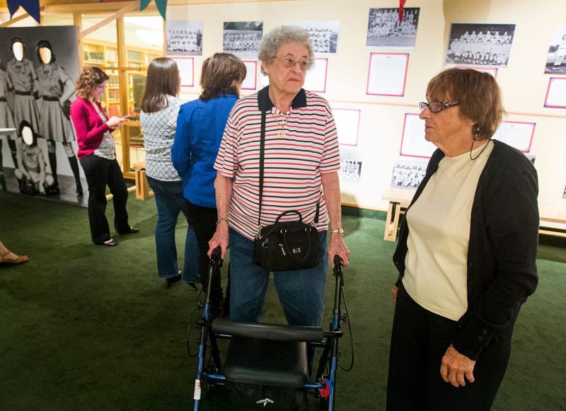 Former All-American Girls Professional Baseball League players Betsy Jochum, left, South Bend Blue Sox (1943-1948) and Jeneane Lesko, Grand Rapids Chicks (1953- 1954) look at the AAGPBL exhibit The History Museum, Thursday, August 6, 2015, in South Bend.