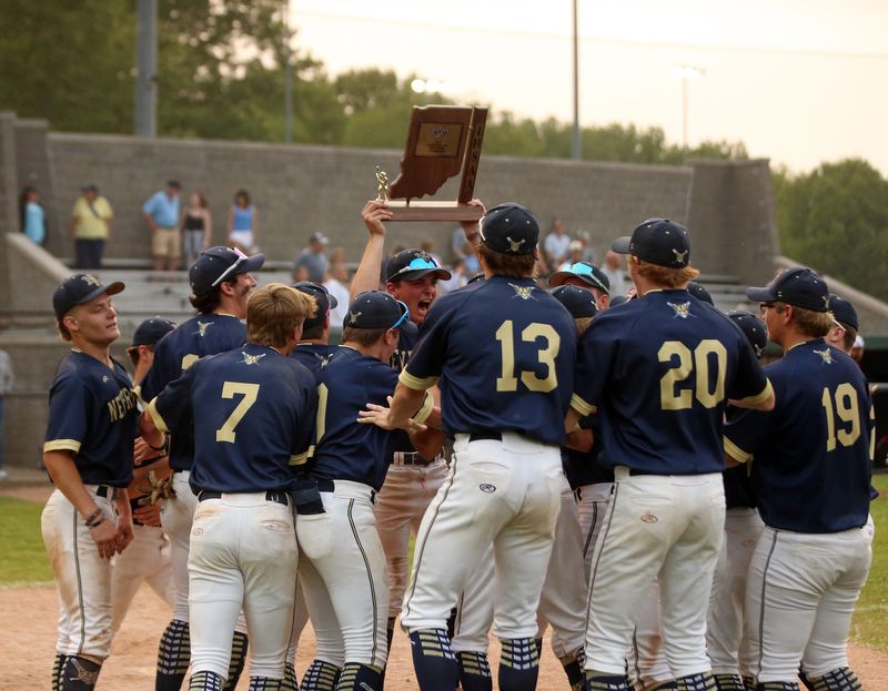 New Prairie senior Jordan Davis raises the trophy up high, screaming in excitement after his Cougars won, 7-4, over Saint Joseph in an IHSAA Class 3A baseball sectional championship game Monday, June 2, 2025, at Centennial Park in Plymouth.