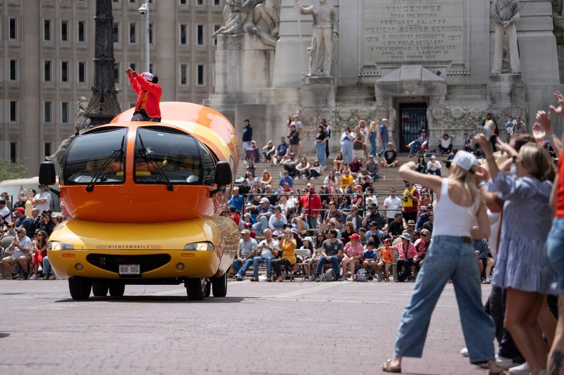Spectators cheer for the Chi Dog Oscar Mayer Wienermobile, Saturday, May 24, 2025, during the 2025 AES 500 Festival Parade in Indianapolis.