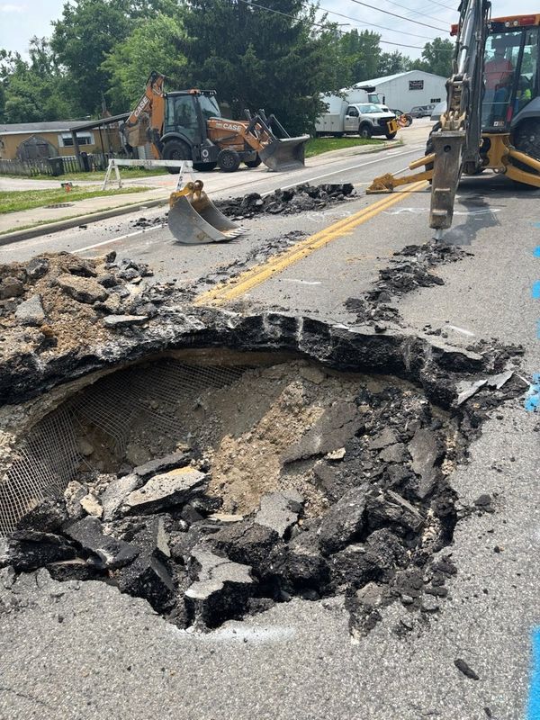 A large sinkhole formed on East Virginia Street near North Willow Road Tuesday. According to Evansville officials, the street will be closed for at least a day as workers attempt to repair the "pavement failure."