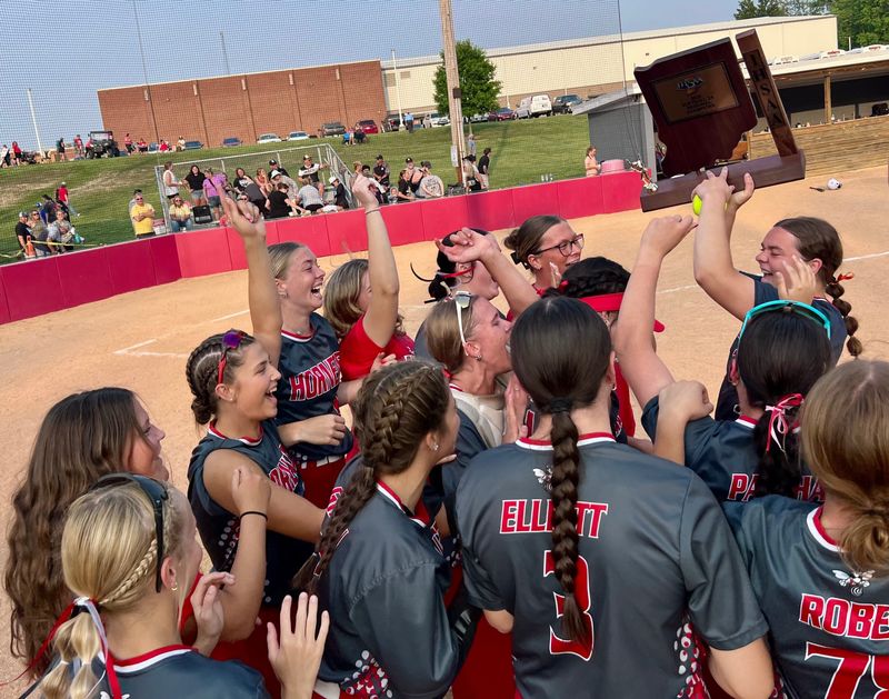 Rossville senior Avery Layton hoists a trophy as her teammates swarm her after the Hornets defeated Rochester 9-2 in the Class 2A regional at Rossville High School on June 3, 2025.