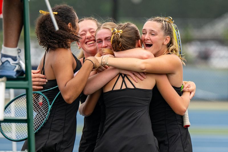 Jasper High School players celebrate the win of their number one doubles team during an IHSAA Girls’ Tennis State Championship Tournament against Brebeuf Jesuit High School, Saturday, June 7, 2025, at North Central High School.
