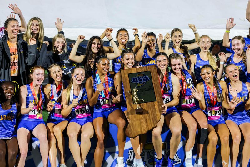 Carmel poses with the first place trophy Saturday, June 7, 2025, during the IHSAA annual girls state track and field finals in Indianapolis.
