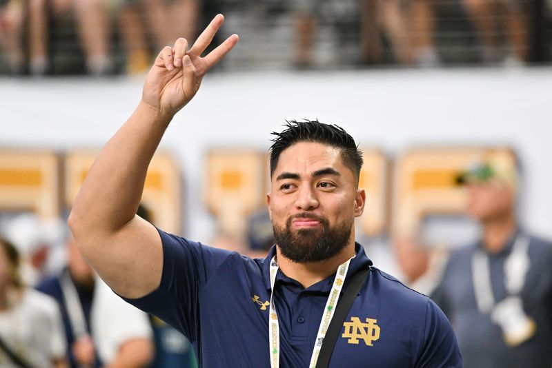 Oct 8, 2022; Paradise, Nevada, USA; Former Notre Dame Fighting Irish player Manti TeÕo waves to the crowd before the game between the Notre Dame Fighting Irish and the BYU Cougars at Allegiant Stadium. Mandatory Credit: Matt Cashore-USA TODAY Sports
