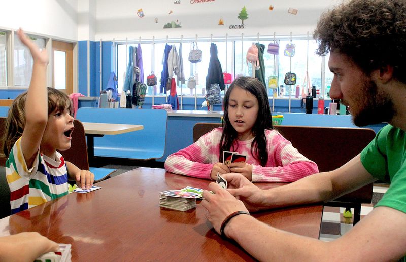 Left to right, Kyle Dasilva, Stella Terrell and staff member Phili Matson play a game of UNO during the Lawrence County Boys and Girls Club Summer Camp on Wednesday, June 11, 2025.
