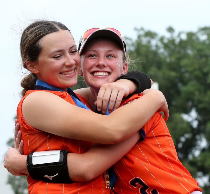 North Newton Spartans Caylee Oxley (1) and North Newton Spartans Riley Higgins (2) hug Friday, June 13, 2025, after the IHSAA Class 1A softball state championship against the Clay City Eels at Purdue University’s Bittinger Stadium in West Lafayette, Indiana. North Newton Spartans won 2-0.