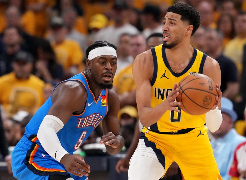 Oklahoma City Thunder guard Luguentz Dort (5) defends Indiana Pacers guard Tyrese Haliburton (0) on Friday, June 13, 2025, during Game 4 of the NBA Finals at Gainbridge Fieldhouse in Indianapolis.
