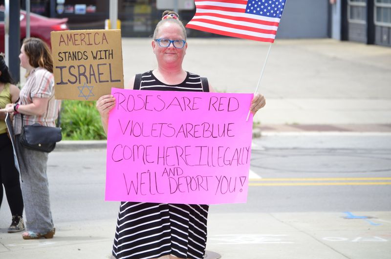Counter-protester Amanda Owens holds up a sign at the "No Kings" rally in Richmond along North A Street on June 14, 2025.