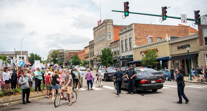The car of the man who stopped near the "No Kings" protest and was eventually taken into custody by Bloomington police is guarded by police while the nearby protest continued at the Monroe County Courthouse on Saturday, June 14, 2025.