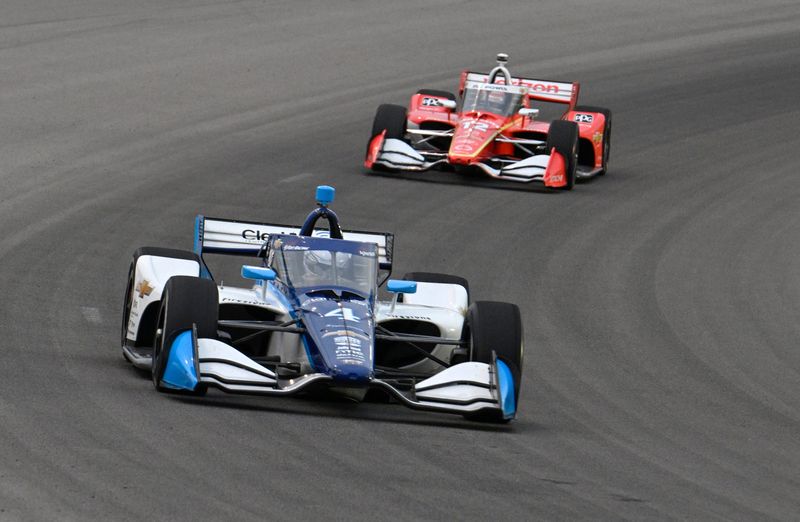 Jun 15, 2025; Madison, Illinois, USA; A. J. Foyt Enterprises driver David Malukas (4) leads Team Penske driver Will Power (12) during the Bommarito Automotive Group 500 at World Wide Technology Raceway. Mandatory Credit: Joe Puetz-Imagn Images