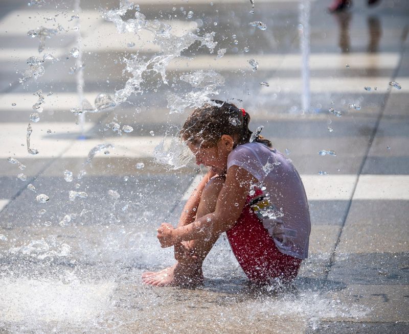A child cools off in the Splash Pad at Switchyard Park on Tuesday, June 10, 2025.