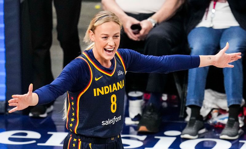 Indiana Fever guard Sophie Cunningham (8) celebrates her teammates Tuesday, June 17, 2025, during a game between the Indiana Fever and the Connecticut Sun at Gainbridge Fieldhouse in Indianapolis.