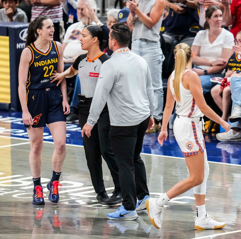 Indiana Fever guard Caitlin Clark (22) talks to Connecticut Sun guard Jacy Sheldon (4) after scoring a 3-pointer Tuesday, June 17, 2025, during a game between the Indiana Fever and the Connecticut Sun at Gainbridge Fieldhouse in Indianapolis. The Indiana Fever defeated the Connecticut Sun, 88-71.