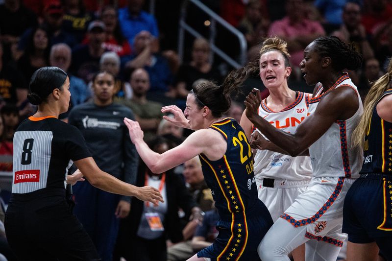 Jun 17, 2025; Indianapolis, Indiana, USA; Connecticut Sun guard Marina Mabrey (3) fouls Indiana Fever guard Caitlin Clark (22) in the second half at Gainbridge Fieldhouse. Mandatory Credit: Trevor Ruszkowski-Imagn Images