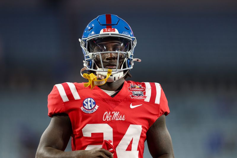 Jan 2, 2025; Jacksonville, FL, USA; Mississippi Rebels running back Ulysses Bentley IV (24) warms up before the Gator Bowl against the Duke Blue Devils at EverBank Stadium. Mandatory Credit: Nathan Ray Seebeck-Imagn Images