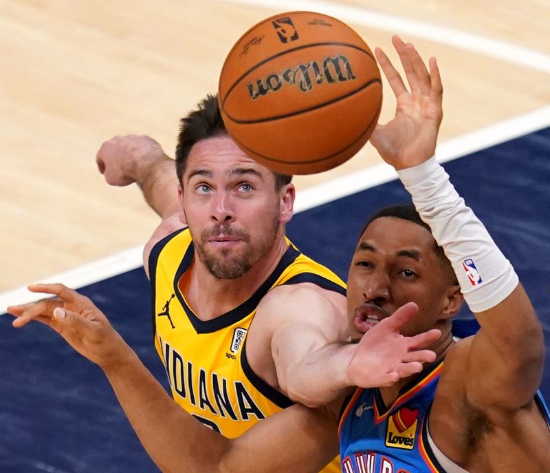 Indiana Pacers guard T.J. McConnell (9) and Oklahoma City Thunder guard Aaron Wiggins (21) fight for a loose ball Thursday, June 19, 2025, during Game 6 of the NBA Finals at Gainbridge Fieldhouse in Indianapolis.