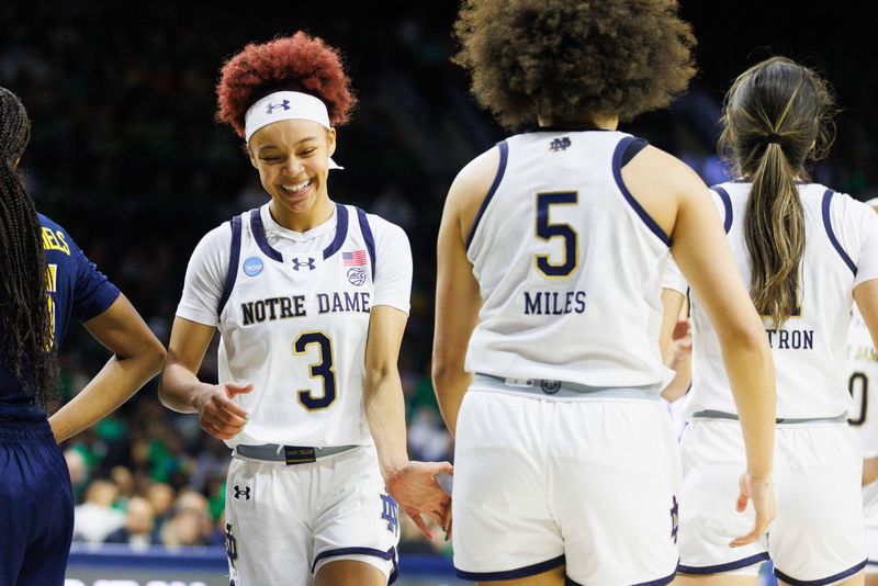 Notre Dame guard Hannah Hidalgo (3) slaps hands with guard Olivia Miles (5) during the second round of the NCAA Women's Basketball Tournament between Notre Dame and Michigan at Purcell Pavilion on Sunday, March 23, 2025, in South Bend.
