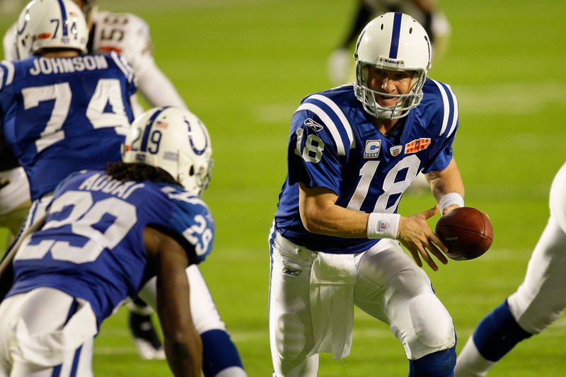 Feb 7, 2010; Miami, FL, USA; Indianapolis Colts quarterback Peyton Manning (18) hands off to running back Joseph Addai (29) during the first half of Super Bowl XLIV against the New Orleans Saints at Sun Life Stadium. Mandatory Credit: Jeff Hanisch-USA TODAY Sports