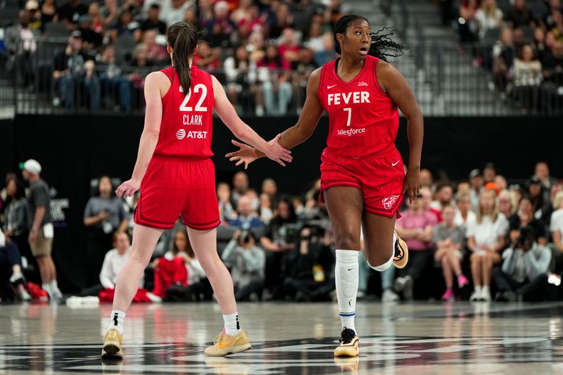 Jun 22, 2025; Las Vegas, Nevada, USA; Indiana Fever center Aliyah Boston (7) celebrates with guard Caitlin Clark (22) after scoring against the Las Vegas Aces during the first half of a WNBA basketball game at T-Mobile Arena. Mandatory Credit: Lucas Peltier-Imagn Images