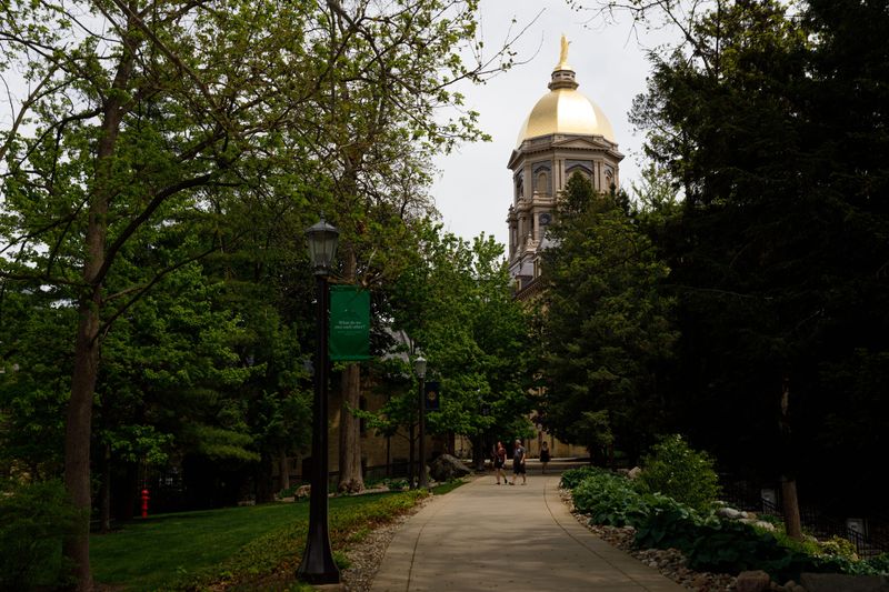 The Golden Dome on top of the University of Notre Dame's Main Administration Building is seen through the trees on Monday, May 12, 2025, in South Bend, Indiana.