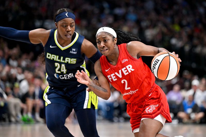 Jun 27, 2025; Dallas, Texas, USA; Indiana Fever guard Aari McDonald (2) drives to the basket past Dallas Wings guard Arike Ogunbowale (24) during the second half at the American Airlines Center. Mandatory Credit: Jerome Miron-Imagn Images