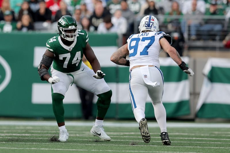 Nov 17, 2024; East Rutherford, New Jersey, USA; New York Jets offensive tackle Olu Fashanu (74) blocks against Indianapolis Colts defensive end Laiatu Latu (97) during the third quarter at MetLife Stadium. Mandatory Credit: Brad Penner-Imagn Images