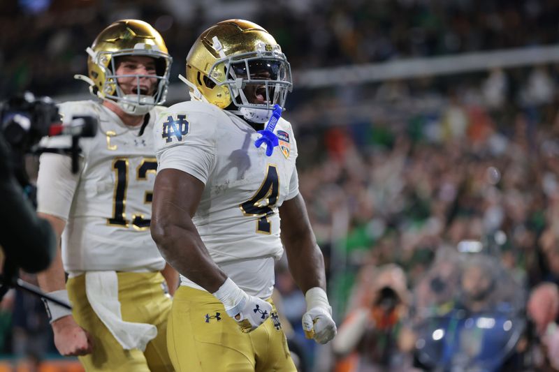 Jan 9, 2025; Miami, FL, USA; Notre Dame Fighting Irish running back Jeremiyah Love (4) celebrates a touch down in the second half against the Penn State Nittany Lions in the Orange Bowl at Hard Rock Stadium. Mandatory Credit: Sam Navarro-Imagn Images