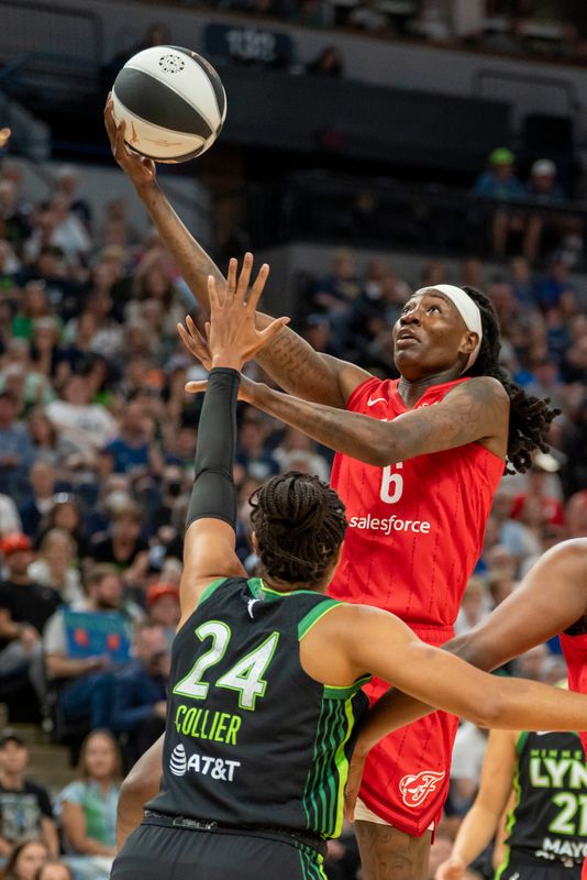 Jul 1, 2025; Minneapolis, Minnesota, USA; Indiana Fever forward Natasha Howard (6) drives to the basket and shoots the ball over Minnesota Lynx forward Napheesa Collier (24) in the first half during the Commissioner's Cup final at Target Center. Mandatory Credit: Jesse Johnson-Imagn Images