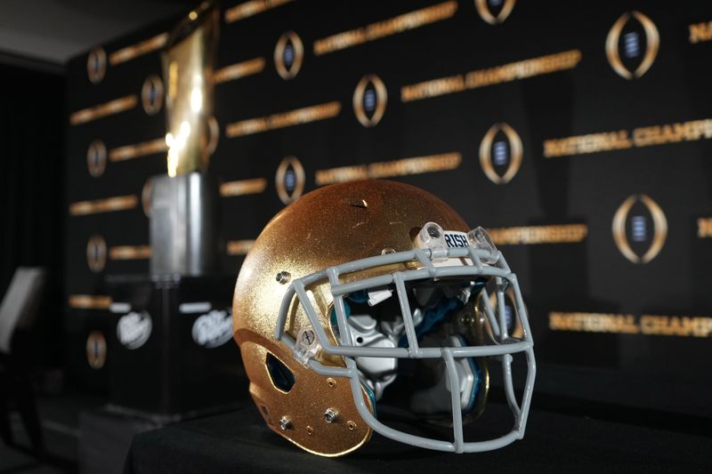 Jan 19, 2025; Atlanta, GA, USA; A Notre Dame Fighting Irish helmet and College Football Playoff National Championship trophy at press conference at The Westin Peachtree Plaza, Savannah Ballroom. Mandatory Credit: Kirby Lee-Imagn Images