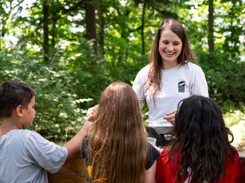 Eagle Creek park manager Jenna McElroy talks to curious park visitors on Thursday, July 3, 2025, at the Eagle Creek Ornithology Center in Indianapolis.