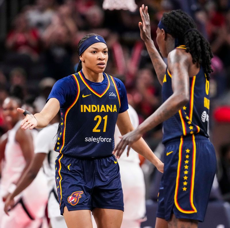 Indiana Fever forward Makayla Timpson (21) and Indiana Fever forward Natasha Howard (6) high five Thursday, July 3, 2025, during a game between the Indiana Fever and the Las Vegas Aces at Gainbridge Fieldhouse in Indianapolis.