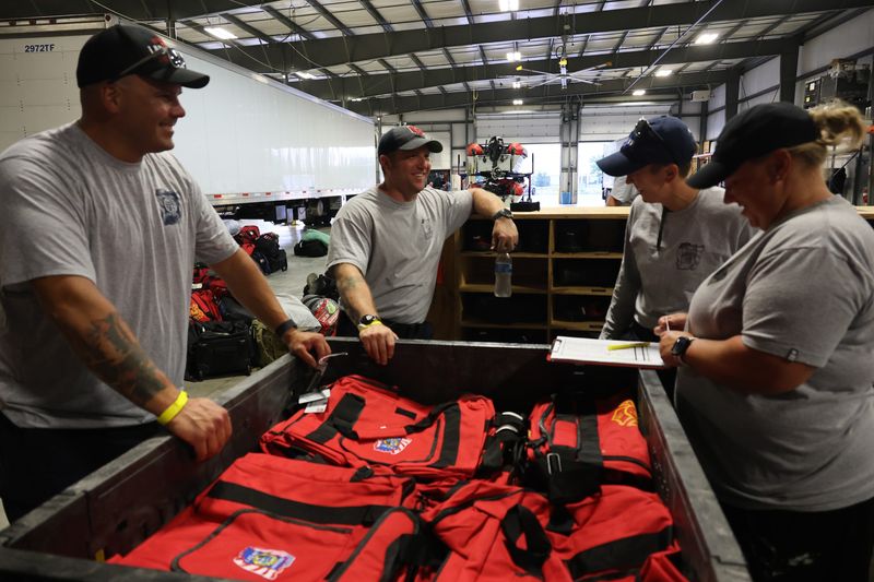 Members of the the Indiana Task Force 1 prepare gear before the task force deploys to San Antonio, Texas to assist with rescue efforts in Kerr County, Texas, on July 8, in Indianapolis, Indiana.