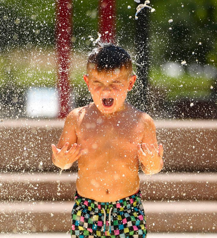 Aiden Rushefsky reacts as the water falls over him at the Splash Pad at Desert Breeze Park in Chandler, on May 28, 2024.