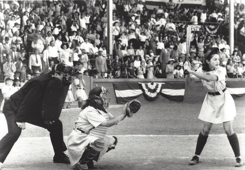 "All the Way" Mae (Madonna), a former dancehall hostess turned professional baseball player, wants to go all the way home on her next hit in "A League of Their Own." Venues Parks & Arts presents a screening of the film July 11, 2025, at Howard Park in South Bend.