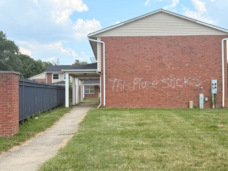 'This place sucks' is spray-painted across the side of one unit inside the Laurelwood apartment complex in Indianapolis, photographed on June 24, 2025.