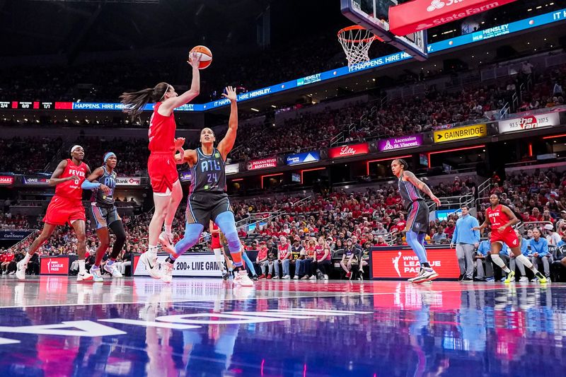Indiana Fever guard Caitlin Clark (22) goes up for a basket against Atlanta Dream forward Brionna Jones (24) on Friday, July 11, 2025, during a game between the Indiana Fever and the Atlanta Dream at Gainbridge Fieldhouse in Indianapolis. The Indiana Fever defeated the Atlanta Dream, 99-82.