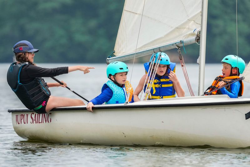 Sophia Capehart, 12, calls out to the young sailors on her boat Thursday, June 12, 2025, during the first week of Sailing Summer Camp with Eagle Creek Sailing Club for children ages 8 to 11. Capehart fell in love with sailing after hearing stories from her grandfather who went to the Massachusetts Maritime Academy and also sailed charter boats in the Caribbean Sea. She then learned the basics of sailing from her cousin on Lake Michigan.