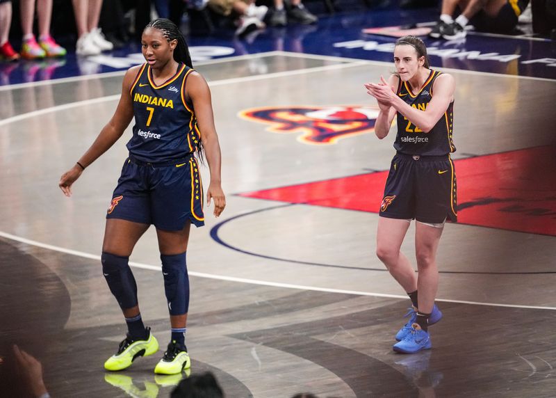 Indiana Fever guard Caitlin Clark (22) claps her hands in excitement with Indiana Fever forward Aliyah Boston (7) on Sunday, July 13, 2025, during the game at Gainbridge Fieldhouse in Indianapolis.